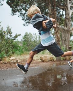 Boy Skipping across a pool of water